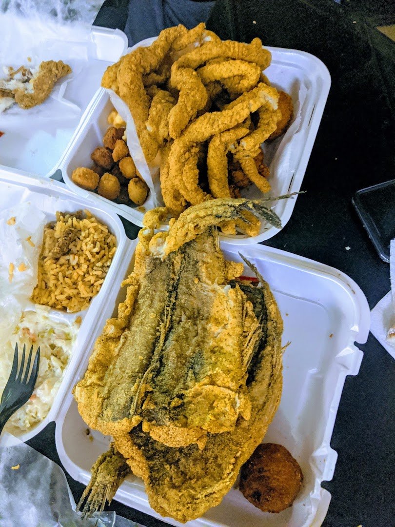 Golden fried fish on a simple plate.